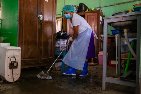 Ma Nyein Myint Oo cleaning a hospital floor wearing protective equipment, in Lemyethna Hospital, Ayeyarwady Region, Myanmar, March 12 2020. 