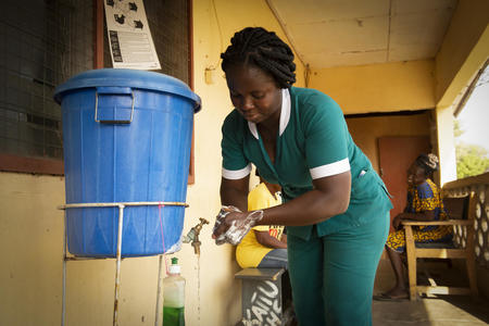 La partera Fostina Sedjoah se lava las manos en el centro de salud de Katiu CHPS en el distrito oeste de Kassena-Nankana, Ghana.